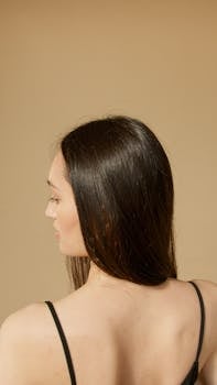 Close-up portrait of a woman with long black hair in a studio setting, showcasing elegance and beauty.
